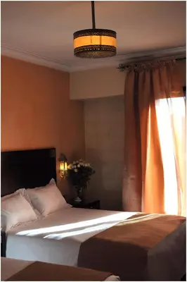a bedroom with a large bed and a window at Mont Gueliz in Marrakech
