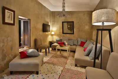 a living room with couches and chairs and a lamp at Riad Dar One in Marrakech