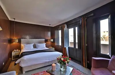 a bedroom with a large bed and a couch at Riad Dar One in Marrakech
