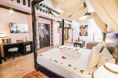 a bedroom with a large white bed in a room at Les Borjs De La Kasbah in Marrakech