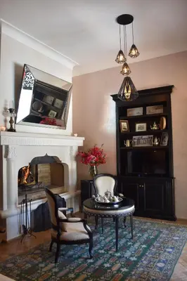 a living room with a table and a fireplace at Demeures d'Orient Riad & Spa in Marrakech