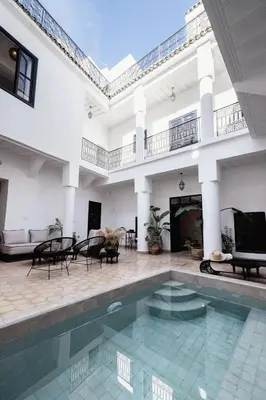 a house with a swimming pool and a living room at Riad 27 & SPA entièrement privatisé in Marrakech