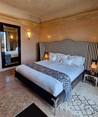 a bedroom with a large bed in a room at Es Saadi Marrakech Resort - Palace in Marrakech