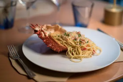 a plate of food with spaghetti and meat on a table at Es Saadi Marrakech Resort - Palace in Marrakech