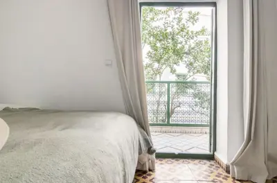 a bedroom with a bed and an open window at Riad Privé Dar Yaël in Marrakech