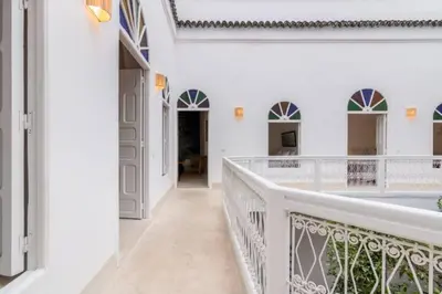 a hallway of a white house with a balcony at DAR SAFIRA in Marrakech