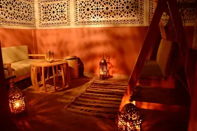 a room with a staircase and a table and a fireplace at Riad Bab Nour in Marrakech