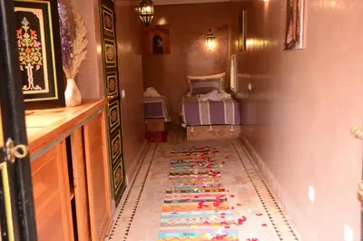 a hallway with a colorful rug on the floor at Riad Bab Nour in Marrakech