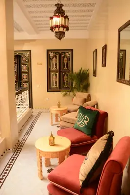 a living room with two couches and a table at Riad Bab Nour in Marrakech