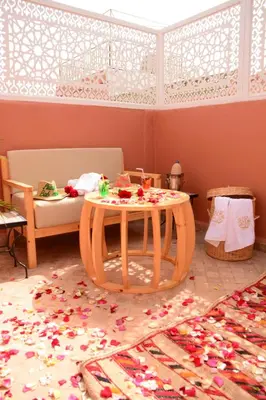 a room with a table with flowers on the floor at Riad Bab Nour in Marrakech