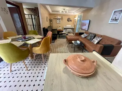 a living room with a couch and a table at Au Riad des Deux Patios - Marrakech in Marrakech