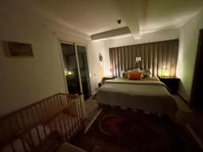 a bedroom with a large bed in a room at Au Riad des Deux Patios - Marrakech in Marrakech
