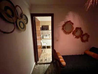 a room with a mirror and a table and a sink at Au Riad des Deux Patios - Marrakech in Marrakech