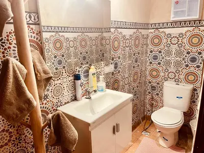 a bathroom with a white sink and a toilet at Au Riad des Deux Patios - Marrakech in Marrakech