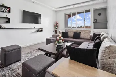 a living room with a couch and a table at Magnifique appartement en plein centre ville in Marrakech