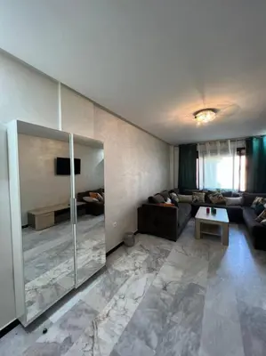 a living room with a couch and a glass door at Vitality Harmony A27 in Marrakech