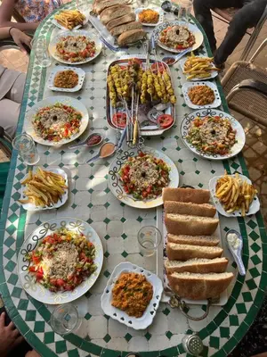 a table with plates of food on it at Riad Mhidou Marrakech in Marrakech