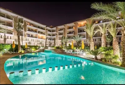 a hotel with a swimming pool at night at Garden Marrakech Luxury in Marrakech