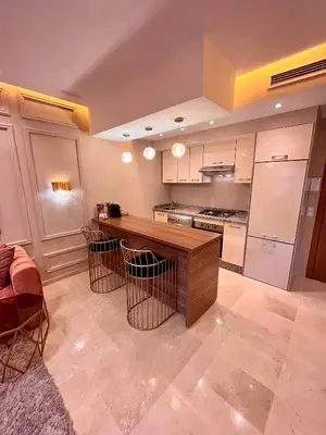 a kitchen with a wooden counter and a refrigerator at Garden Marrakech Luxury in Marrakech