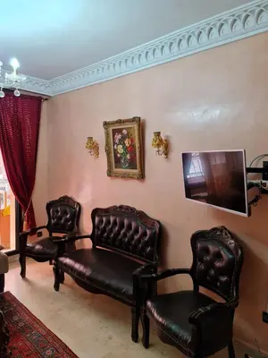 a living room with two chairs and a couch at 1 Bed Flat - Sleeps 2 - Parking - Wifi in Marrakech