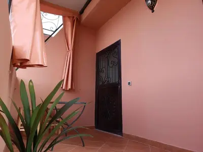a door in a room with a plant in front of it at Studio l'Oasis de la Palmeraie in Marrakech