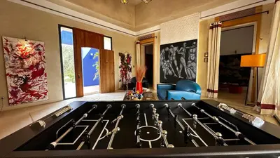 a stove top oven with a bunch of utensils at Les Jardins de Kesali By La Siredrah in Marrakech