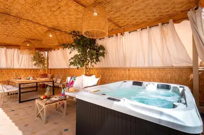 a large jacuzzi tub in a room with a table at LES TANNEURS PENTHOUSE MARRAKECH in Marrakech
