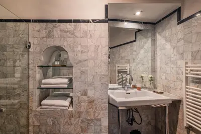 a bathroom with a sink and a mirror at Riad Kitula in Marrakech
