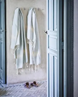 a pair of flip flops on the floor next to a door at Riad Kitula in Marrakech