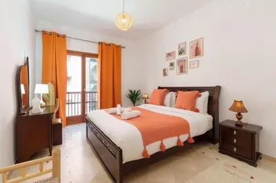 a bedroom with a large bed and a television at Appartement Chic Gueliz Plaza avec Vue in Marrakech