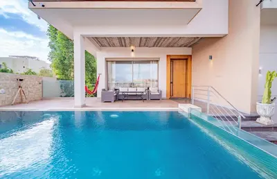 a swimming pool with a patio and a house at Villa moderne avenue M6 in Marrakech