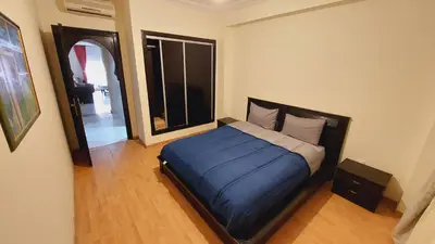 a bedroom with a bed with a blue blanket at Cosy apartment in Marrakesh, Guliz in Marrakech