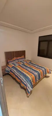 a bed with a colorful blanket on it in a room at New Apartment in Marrakesh Guliz in Marrakech