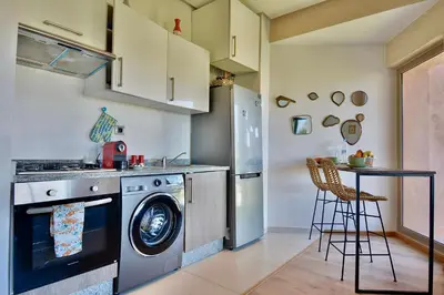 a kitchen with a washer and a dishwasher at Appartement, Prestigia Marrakech in Marrakech