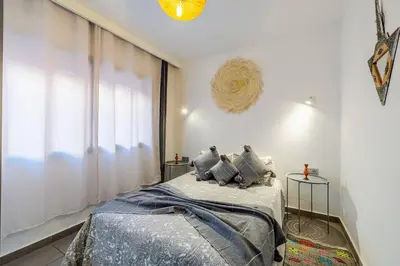 a bedroom with a bed and a window at Charming Cozy 2 Bedrooms central Gueliz in Marrakech