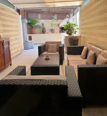 a living room with couches and a table at GUELIZ, majorelle, Beautiful apartment with large terrace in Marrakech