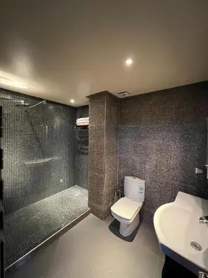 a bathroom with a shower and a toilet and a sink at GUELIZ, majorelle, Beautiful apartment with large terrace in Marrakech