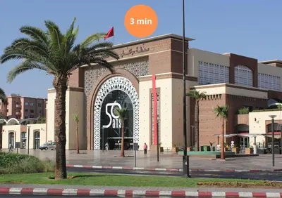 a building with a palm tree in front of it at Chic Hideaway - Marrakech Centre in Marrakech