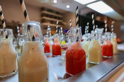 a row of different colored drinks sitting on a counter at Ari Boutique Hôtel - Adult Only in Marrakech