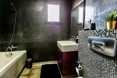 a bathroom with a sink and a bath tub and a sink at Elite Escape - Marrakech Centre in Marrakech