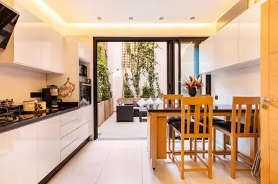 a kitchen and dining room with a table and chairs at Loft Duplex Familial 200m2 Neuf - Centre Gueliz in Marrakech