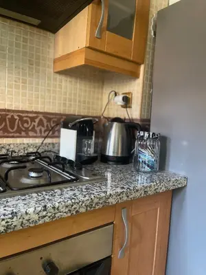 a kitchen counter with a stove and a sink at Atlas golf resort in Marrakech