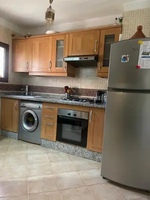 a kitchen with a stainless steel refrigerator and a dishwasher at Atlas golf resort in Marrakech